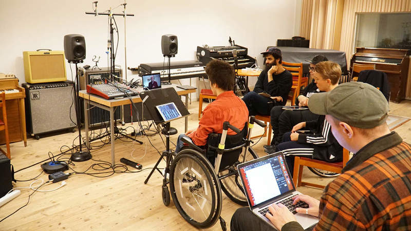 A group of musicians are texting coproduction of music online